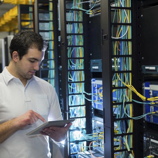 IT technician with network equipment and cables